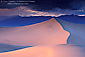 Pink and blue pastel light at sunset on desert sand dune after a storm, near Stovepipe Wells, Death Valley National Park, California